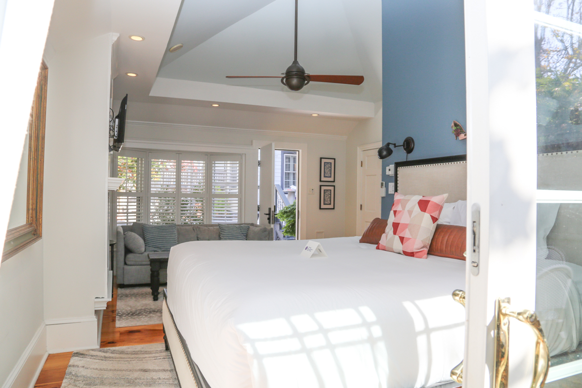 Bright room with large bed and red pillows