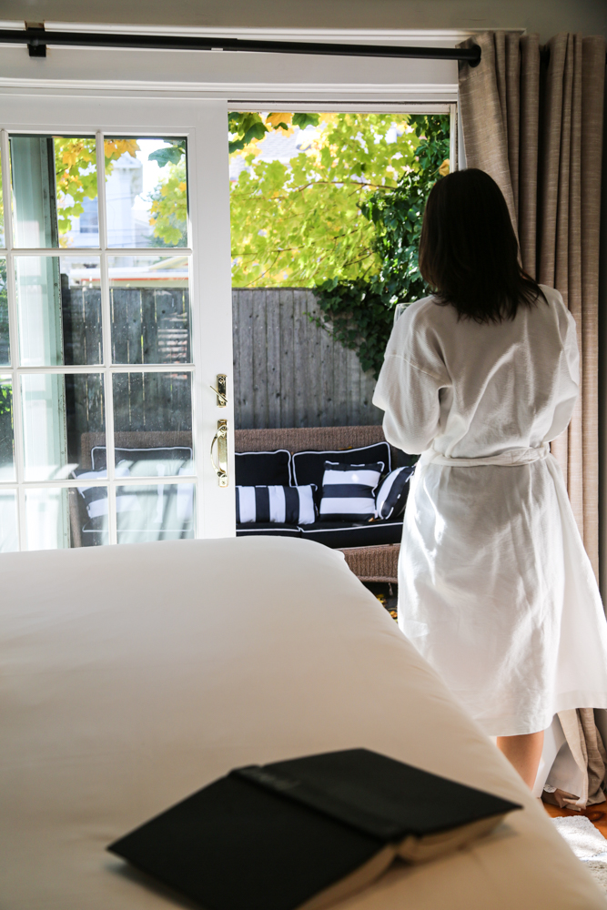 Woman in bathrobe by patio door
