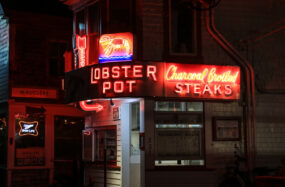Lobster Pot restaurant with neon signs at night