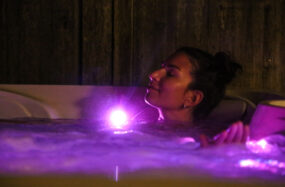 Woman relaxing in glowing hot tub