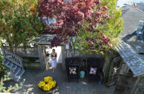 Courtyard with trees, flowers, and a person walking through
