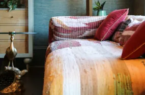 Cozy bed with lighting and pink pillows