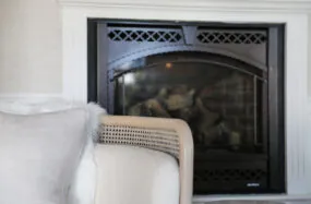 Fireplace with an armchair infront