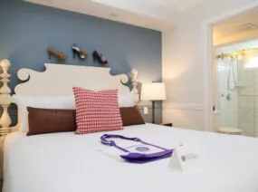 Bedroom with pink pillow and folded robe on the bed